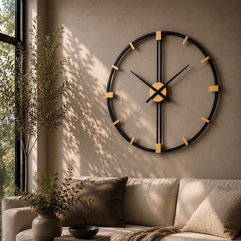 May include: A large circular wall clock featuring a thin black metal frame with gold-colored rectangular hour markers. The clock has two long vertical black bars intersecting at the center, where two black hands are attached to a gold circular hub.