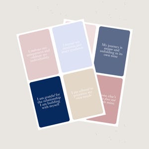 May include: A collection of affirmation cards with rounded corners. Each card has a pastel background and white text. The cards feature phrases such as "I embrace my uniqueness" and "My journey is unique." The color palette includes pink, blue, and beige.