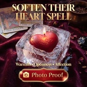 May include: A red heart-shaped candle with a lit wick sits inside a clear, textured ice-like block. The text reads SOFTEN THEIR HEART SPELL, Warmth • Openness • Affection, and Photo Proof. Tarot cards and a brass bowl are visible nearby.