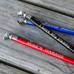 May include: Three tire pressure gauges with personalized engravings. The gauges are red, black, and blue. The red gauge says "Mike's Garage", the black gauge says "I Love My Daddy", and the blue gauge says "Kevin Miller".