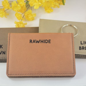 May include: Three leather wallets in different shades of brown. The wallets are labeled "Dark Brown", "Rawhide", and "Light Brown".