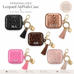 May include: Personalized leopard print AirPods cases in black, brown, pink, and rose gold. Each case has a gold keychain, tassel, and heart charm. The cases are personalized with initials such as "M.A", "KJR", "AVA", "KATIE", and "SARAH". The text "Your Style. Your Initials." is also visible.