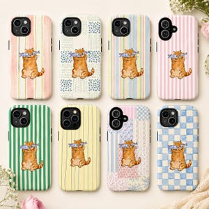 May include: A collection of phone cases featuring a watercolor illustration of an orange tabby cat holding a fish. Each case has a different background pattern, including stripes, floral, and patchwork designs.