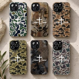May include: Six smartphone cases arranged in two rows, each featuring a unique camouflage pattern in shades of green, brown, black, and gray. Every case displays a white cross symbol centered above the white text that reads Jesus Saves.