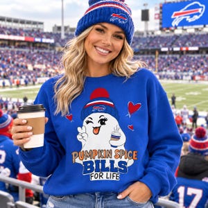 May include: A royal blue sweatshirt featuring a graphic of a white ghost wearing a blue and red knit hat, winking, and holding a coffee cup. The text reads PUMPKIN SPICE BILLS FOR LIFE. The ghost is surrounded by small red hearts.