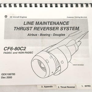 May include: A spiral-bound manual titled "LINE MAINTENANCE THRUST REVERSER SYSTEM" with a diagram of an aircraft engine. The manual is for Airbus, Boeing, and Douglas aircraft, with the model CF6-80C2. The cover includes the GE Aircraft Engines logo and Customer Training Services.
