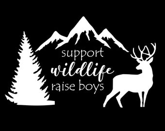 May include: White silhouette design of a mountain range, a pine tree, and a deer with the text "support wildlife raise boys".