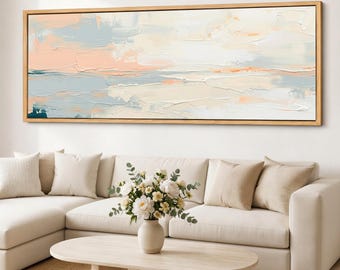 Impressão em tela com paisagem costeira em tons pastel, arte de parede emoldurada com tema de praia, panorama em tons neutros de azul e rosa, arte horizontal ampla para sala de estar.