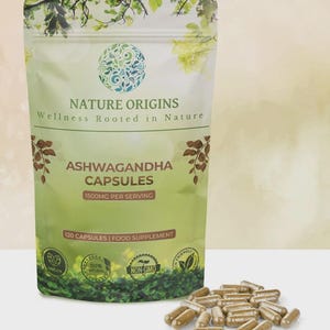 May include: A green and white pouch of "Nature Origins" Ashwagandha capsules, with the text "Wellness Rooted in Nature." The pouch contains 120 capsules, 1500mg per serving, and is labeled as vegan, natural, and non-GMO. A pile of capsules is in front.