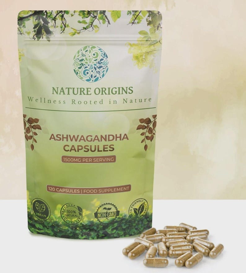 May include: A green and white pouch of "Nature Origins" Ashwagandha capsules, with the text "Wellness Rooted in Nature." The pouch contains 120 capsules, 1500mg per serving, and is labeled as vegan, natural, and non-GMO. A pile of capsules is in front.