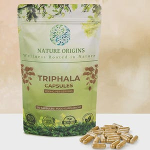 May include: A package of Triphala capsules from Nature Origins, a food supplement. The package is light green with the text "TRIPHALA CAPSULES" and "1650MG PER SERVING". The image also shows a pile of capsules.
