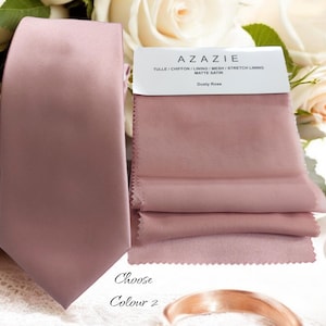 May include: A dusty rose satin tie with the text "Choose Colour 2" and a sample of dusty rose fabric with the text "Azazie Tulle | Chiffon | Lining | Mesh | Stretch Lining Matte Satin Dusty Rose".