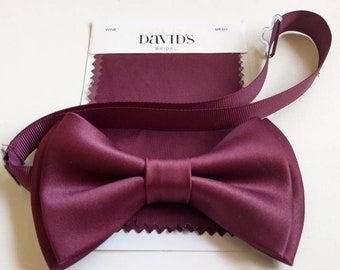May include: A burgundy bow tie with a matching fabric swatch from David's Bridal.