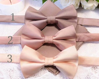 May include: Three bow ties in different shades of pink. The bow ties are made of satin and have a classic shape. The bow ties are numbered 1, 2, and 3.