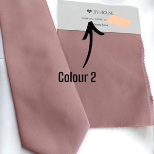 May include: A dusty rose colored tie made of chiffon and satin fabric. The tie is shown next to a fabric swatch with the text "JJ's House Chiffon / Satin / Chiffon Dusty Rose".