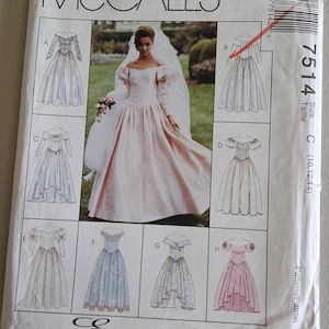 May include: McCall's sewing pattern envelope featuring a bride in a pink wedding dress with a veil. The envelope includes illustrations of various wedding dress designs. The text "Express Yourself" is printed at the bottom.