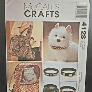 May include: McCall's Crafts pattern 4128. The image shows a pet carrier, a tote bag, and several dog collars. The pattern includes a cat in a tote bag, a dog with a collar, and a backpack-style pet carrier with a cat.