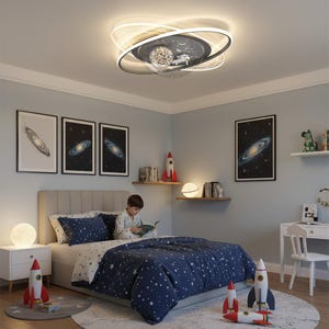 May include: A child's bedroom with a space theme. The room features a bed with a navy blue comforter and star pattern, galaxy artwork, and rocket ship decor. A unique ceiling light fixture with a planet and spaceship design illuminates the room.