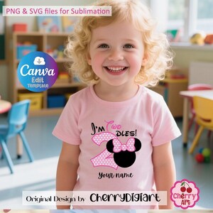 May include: A pink t-shirt with a pink and white polka dot number 2 and a black and pink Minnie Mouse head with a bow. The text "I'm Too DLES!" is above the number and "Your name" is below the number. The shirt is being worn by a young girl with curly blonde hair.