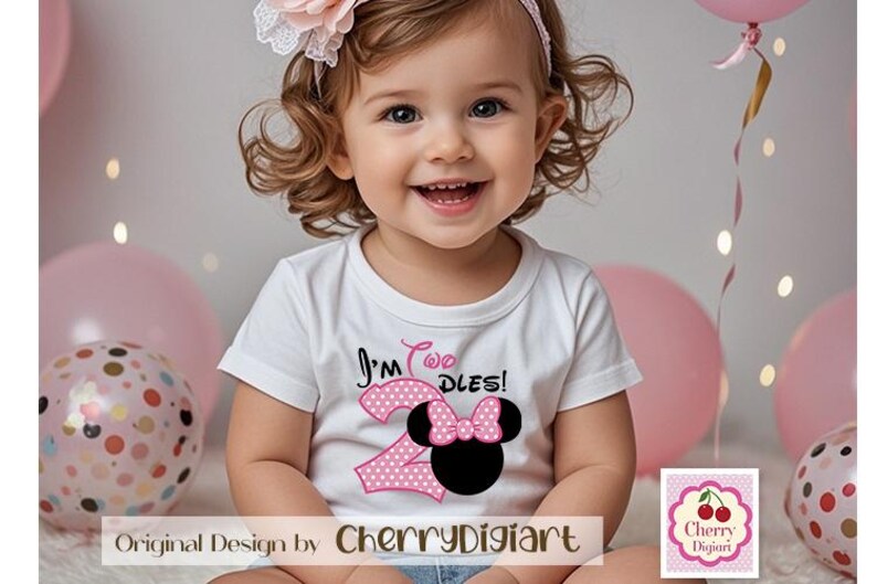 May include: A young girl wearing a white shirt with pink polka dots and the text "I'm Two Dles!" with a pink and black Minnie Mouse graphic. The girl is wearing a headband with a pink flower.