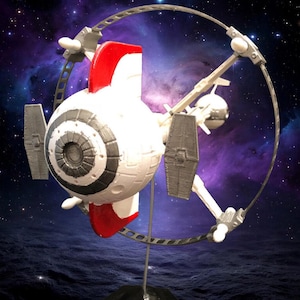 May include: A white and red spaceship model with a circular frame and a black base. The model has a detailed design with grey and black accents. The background features a starry sky and a nebula.