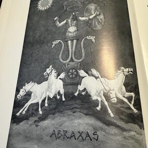 Puede incluir: Una ilustraci&oacute;n en blanco y negro de Abraxas, una figura con cabeza de gallo, torso humano y piernas de serpiente, sosteniendo un l&aacute;tigo y un escudo. La figura est&aacute; en un carro tirado por cuatro caballos blancos, bajo un sol y una luna.