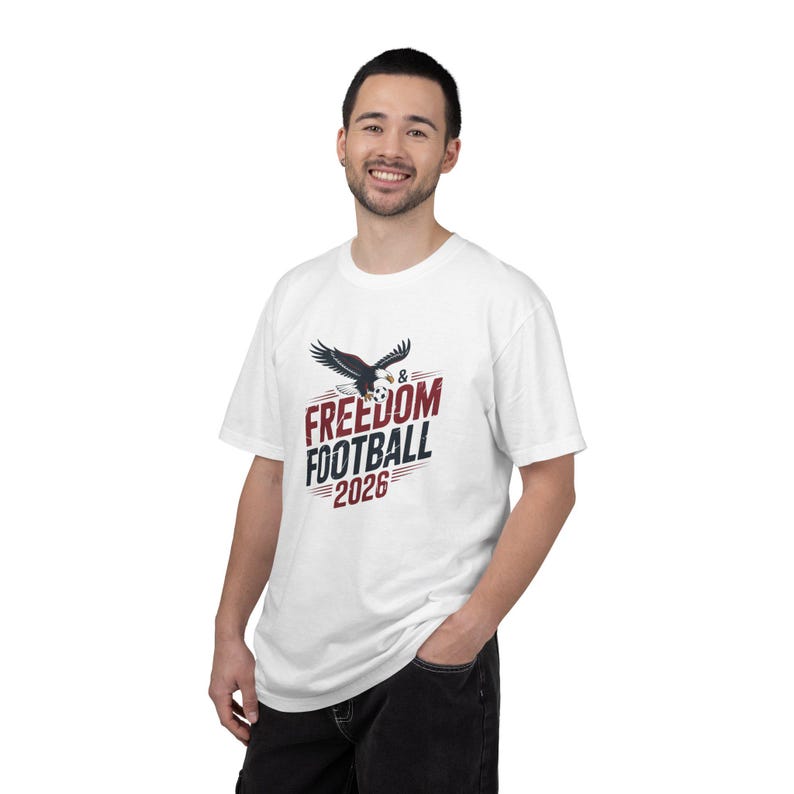 Man wearing white t-shirt with eagle, "Freedom & Football 2026" text.