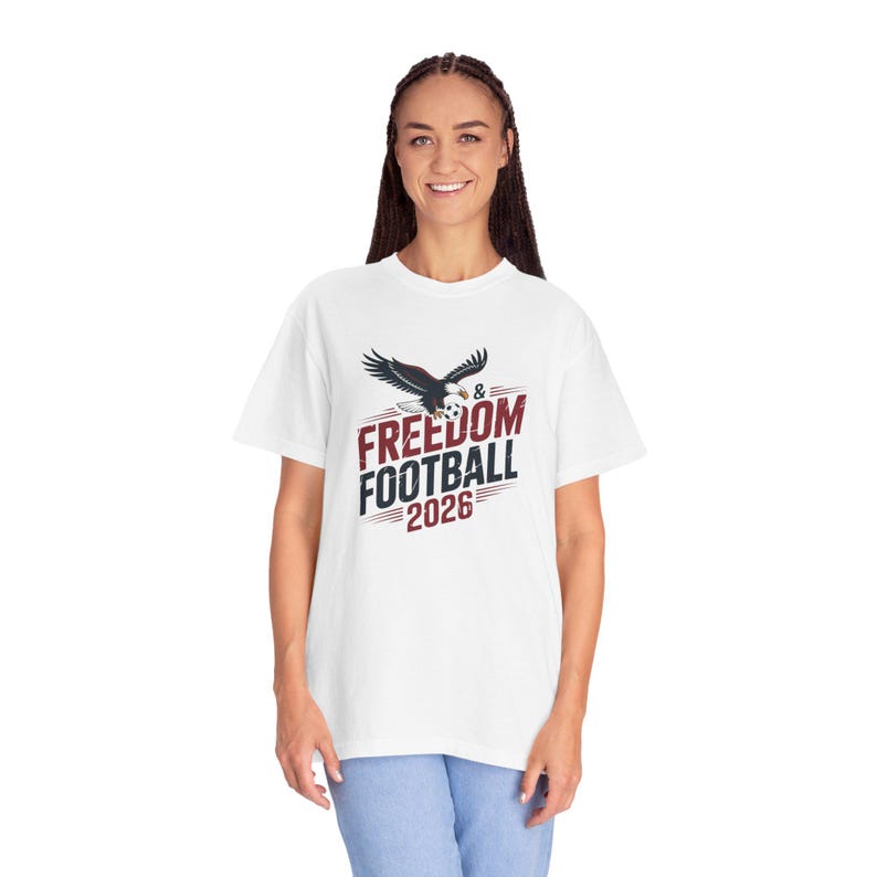 White t-shirt with eagle and "FREEDOM & FOOTBALL 2026" graphic.