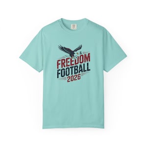 T-shirt with eagle, "Freedom Football 2026" text and soccer ball.