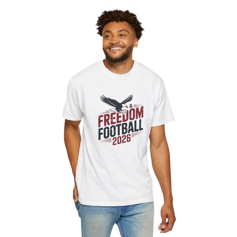 White t-shirt with eagle graphic and "Freedom Football 2026" text.