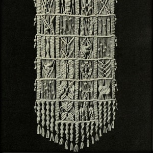 May include: A white macrame wall hanging with a geometric design and a fringe border. The hanging is titled "Tick Tock Knits".