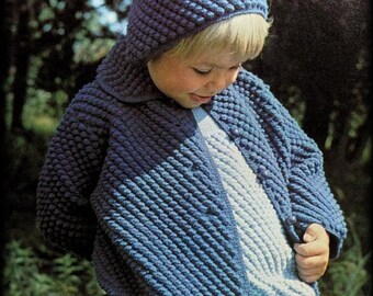 May include: A blue crocheted hooded jacket with a textured stitch pattern. The jacket is worn by a child and has a white crocheted undershirt. The text "Tick Tock Knits" is visible in the bottom right corner of the image.