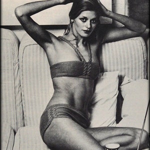 May include: A black and white photograph of a woman wearing a knitted bikini top and matching bottoms. She is sitting on a sofa with a striped pattern. The text "Tick Tock Knits" is visible at the bottom of the image.