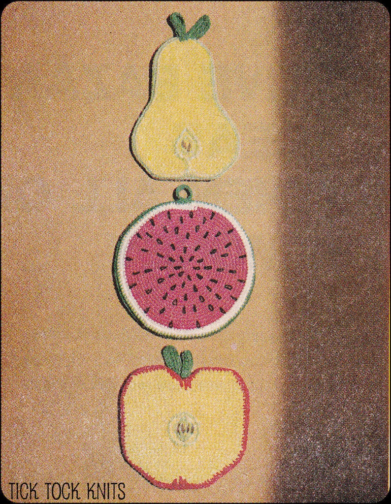 May include: Three crocheted pot holders shaped like a pear, watermelon, and apple. The pear is yellow with green leaves, the watermelon is red with black seeds, and the apple is yellow with a green stem and leaves. The pot holders are arranged vertically on a brown background. The text "TICK TOCK KNITS" is at the bottom of the image.