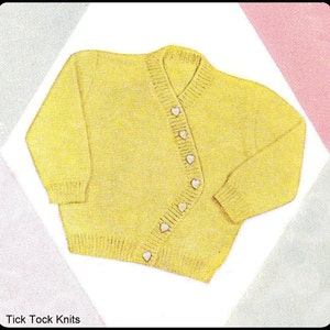 May include: A yellow knitted cardigan with a button-up front and a V-neck. The cardigan has white heart-shaped buttons. "Tick Tock Knits" is printed at the bottom of the image.