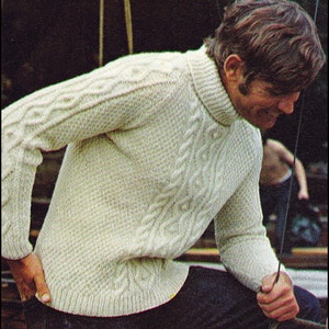 May include: A white cable knit jumper with a turtleneck collar. The jumper is made of a soft, warm material and has a classic, timeless design.