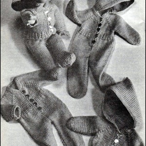 May include: Three knitted doll outfits, including a hooded jumpsuit, a jumpsuit with a separate jacket, and a hooded jumpsuit with a separate jacket. The outfits are all grey and have button fastenings.