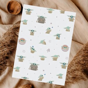 May include: White paper with a repeating pattern of a green alien character with large ears and big eyes. The character is depicted in various poses, some with a small bag. The design includes small stars and butterflies.