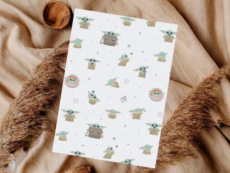 May include: White paper with a repeating pattern of a green alien character with large ears and big eyes. The character is depicted in various poses, some with a small bag. The design includes small stars and butterflies.