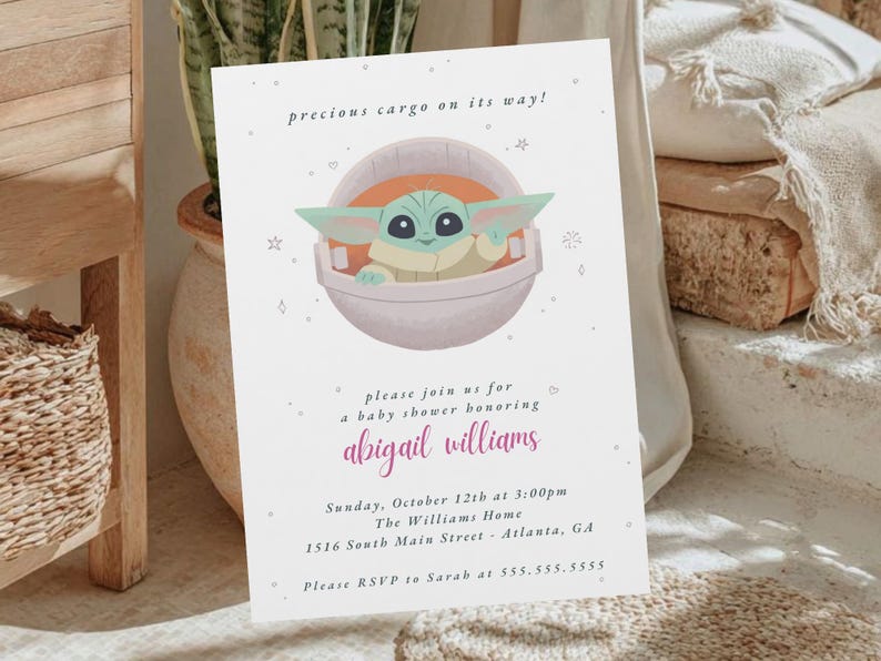 May include: Baby shower invitation featuring a cartoon character in a pod, with the text "precious cargo on its way!". The invitation includes details for a baby shower honoring Abigail Williams.