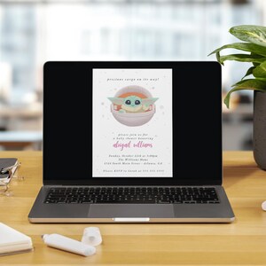 May include: A laptop displays a baby shower invitation featuring a cartoon character in a pod. The invitation text reads "precious cargo on the way!" and includes details for a baby shower honoring Abigail Williams.