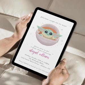 May include: Digital baby shower invitation featuring a cartoon character in a pod. The invitation includes the text "precious cargo on its way!" and details for a baby shower honoring Abigail Williams, including the date, time, and location.