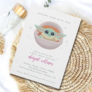 May include: Baby shower invitation featuring a cartoon character in a pod, with the text "precious cargo on its way!". The invitation includes details for a baby shower honoring Abigail Williams, with the date, time, and location.