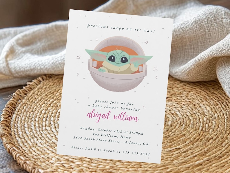May include: A baby shower invitation featuring a cartoon character in a pod. The invitation includes the text "precious cargo on its way!" and details for a baby shower honoring Abigail Williams, including the date, time, and location.