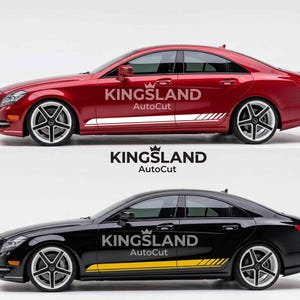 May include: Two cars, one red and one black, each with the text "KINGSLAND AutoCut" and a side stripe design. The red car has white stripes, and the black car has yellow stripes. Both cars have black and silver wheels.