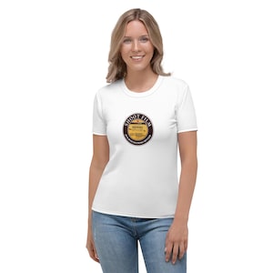 May include: White t-shirt featuring a circular graphic on the front. The graphic has the words "SHOOT FILM" in a circular border, and the text "IT'S JUST FUCKING BETTER" below. The design is vintage-inspired.