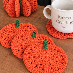 May include: A set of orange crochet pumpkin coasters with green stems, a three-dimensional crochet pumpkin, and a white ceramic mug with the text Karen Crochet and a heart symbol. A circular badge in the corner displays the text CROCHET PATTERN PDF.