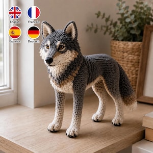 May include: A crochet wolf figurine crafted with grey, white, and tan yarn. The wolf features pointed ears, amber-colored eyes, a black nose, and a textured coat. It stands on four legs with a bushy tail, showcasing detailed stitching throughout its body.