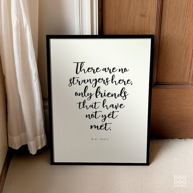 May include: A black framed print with a white background and black text that reads "There are no strangers here, only friends that have not yet met. W.B. Yeats".