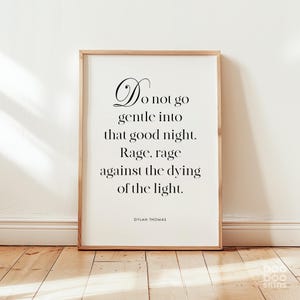 May include: A framed print with a white background and black text. The text reads "Do not go gentle into that good night. Rage, rage against the dying of the light."  The text is attributed to Dylan Thomas.